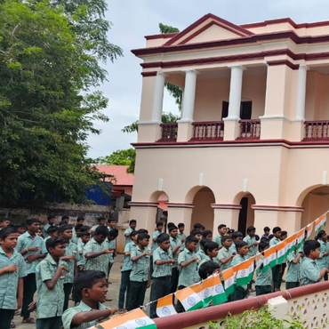 Students saluting with Indian flags during the Independence Day celebrations